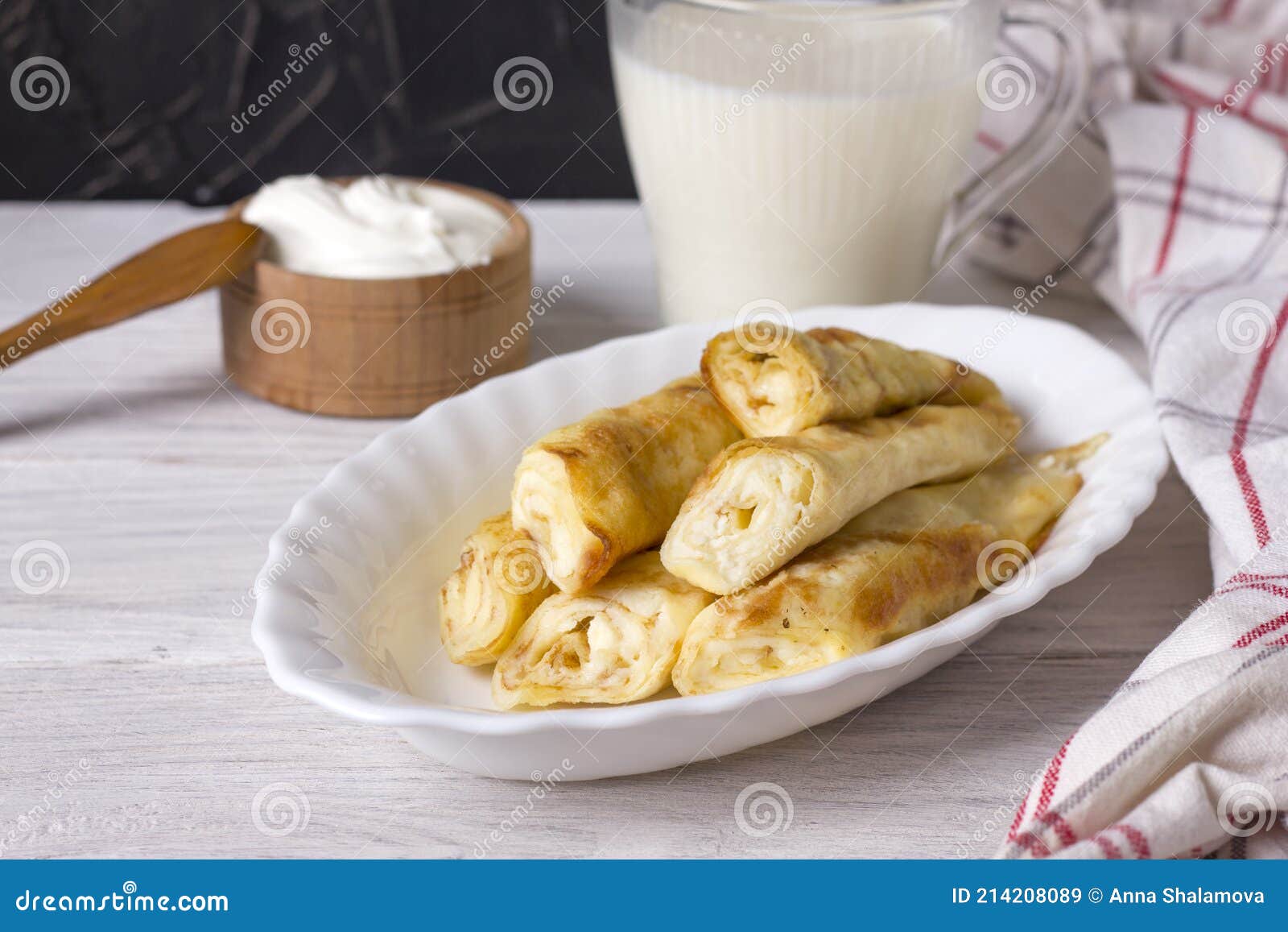 Rolled Up Thin Pancakes Stuffed with Cottage Cheese with Raisins Stock