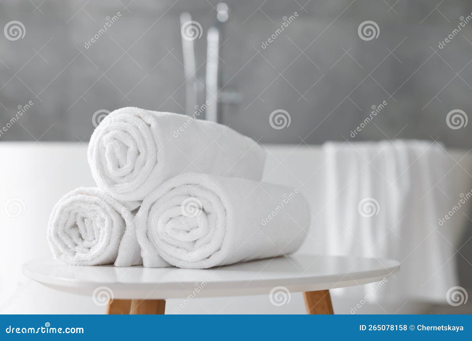 Rolled White Towels on Stool in Bathroom. Space for Text Stock Photo