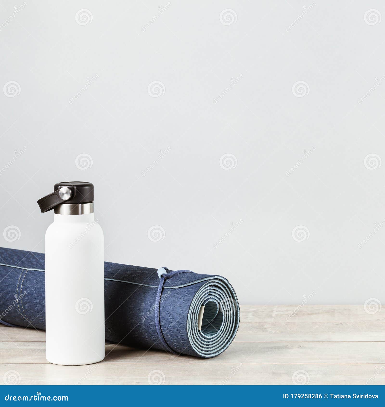 Rolled Yoga Mat and Metal Water Bottle Stock Photo - Image of