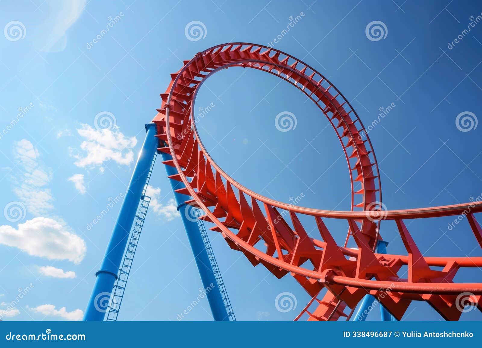 a roller coaster loop rises high into the sky, showcasing its vibrant colors under the bright sun, providing excitement for thrill