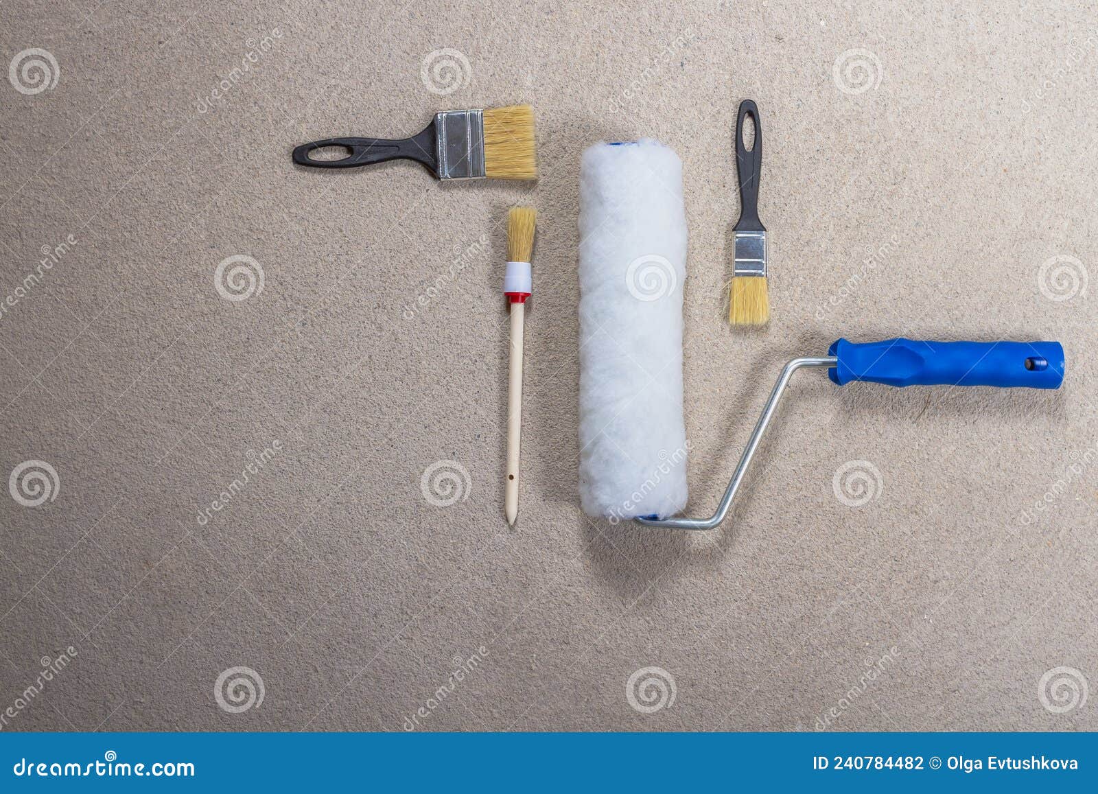 Roller for Paint and Brushes for Painting Walls on a Gray Concrete