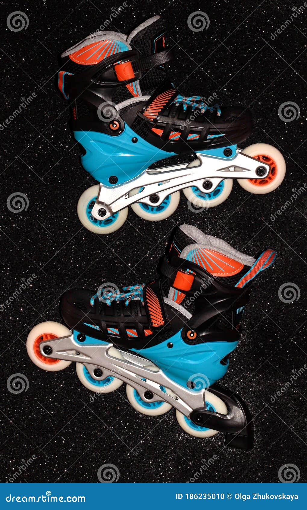 Roller Skates on a Black Background. Rollers are Black and Blue with