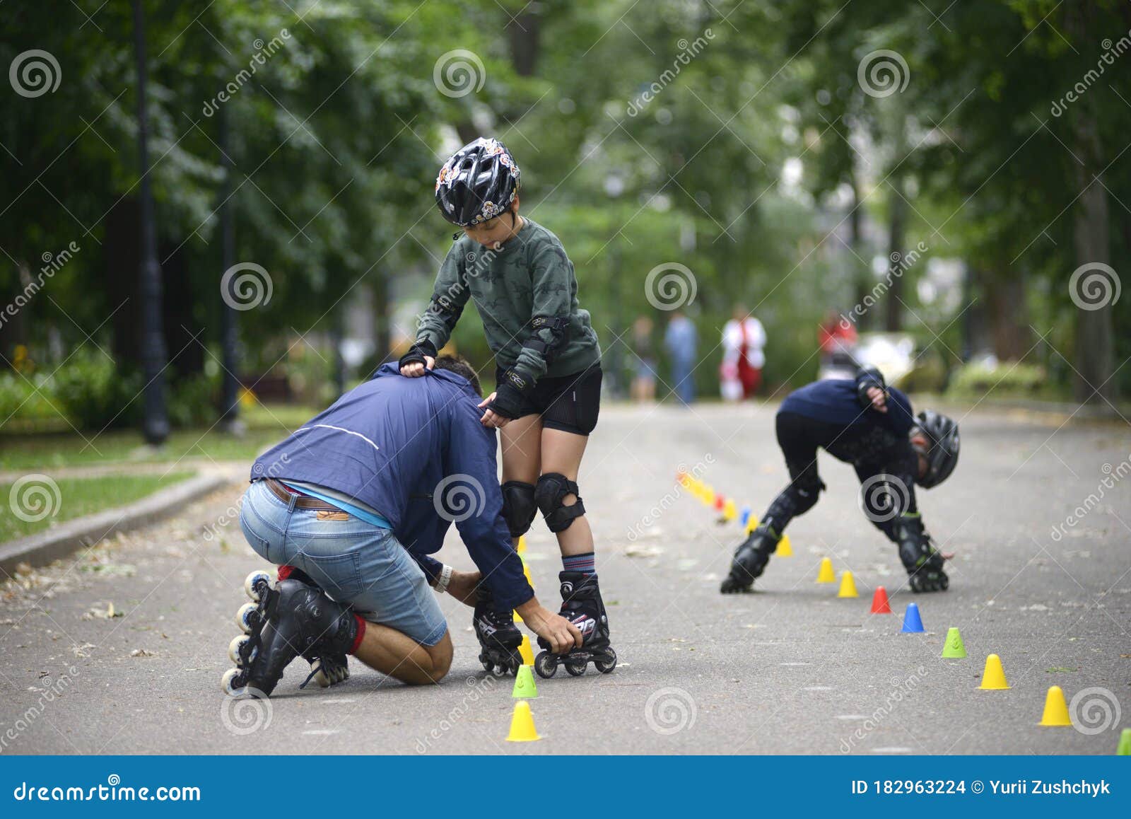 Rollerblading. Trainer Corrects Boy Movements Teaching of Artistic