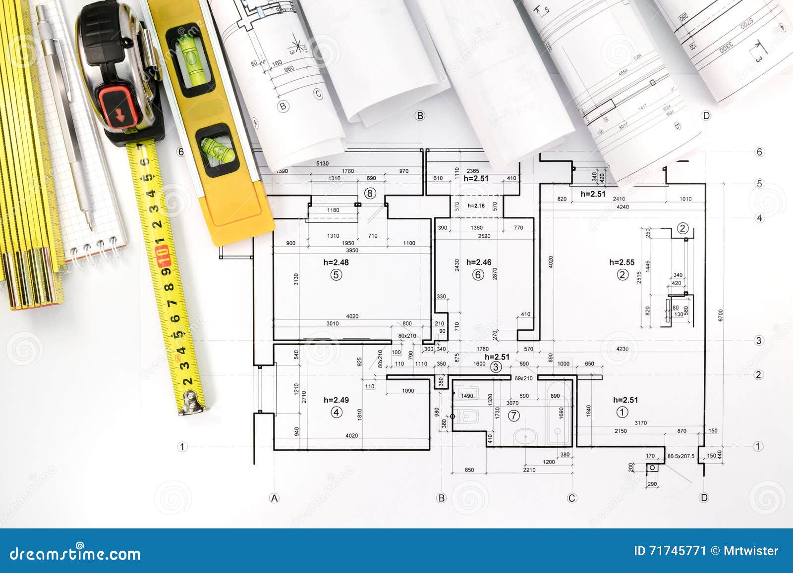 Rolls Of Architectural Blueprints And House Plan With