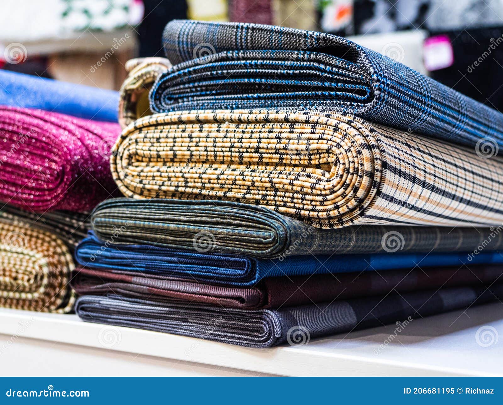 Rolls of Different Checkered Fabrics for Sewing Coats Closeup. Samples