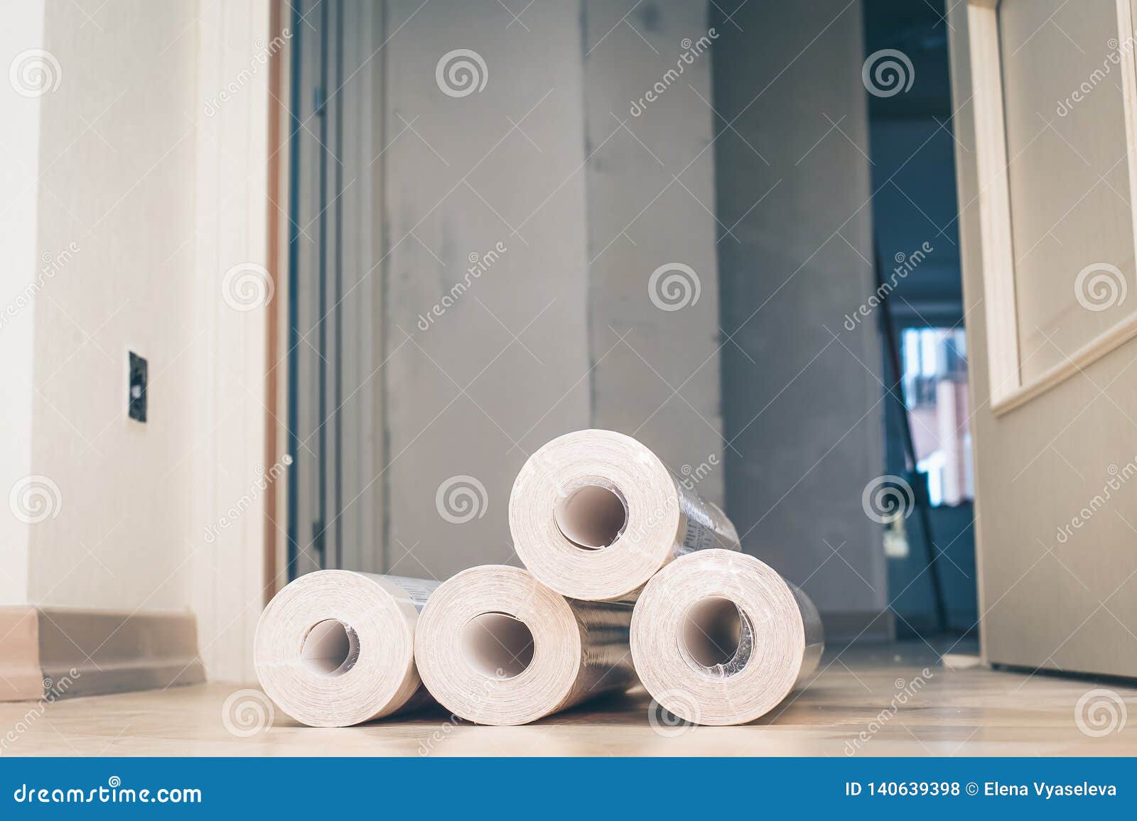 Rolls Of New White Wallpaper Are On The Floor In The