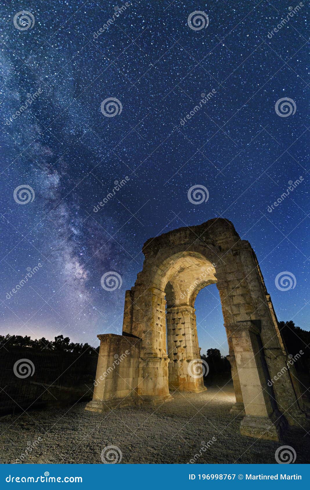 roman arch of caparra under the stars with the milky way