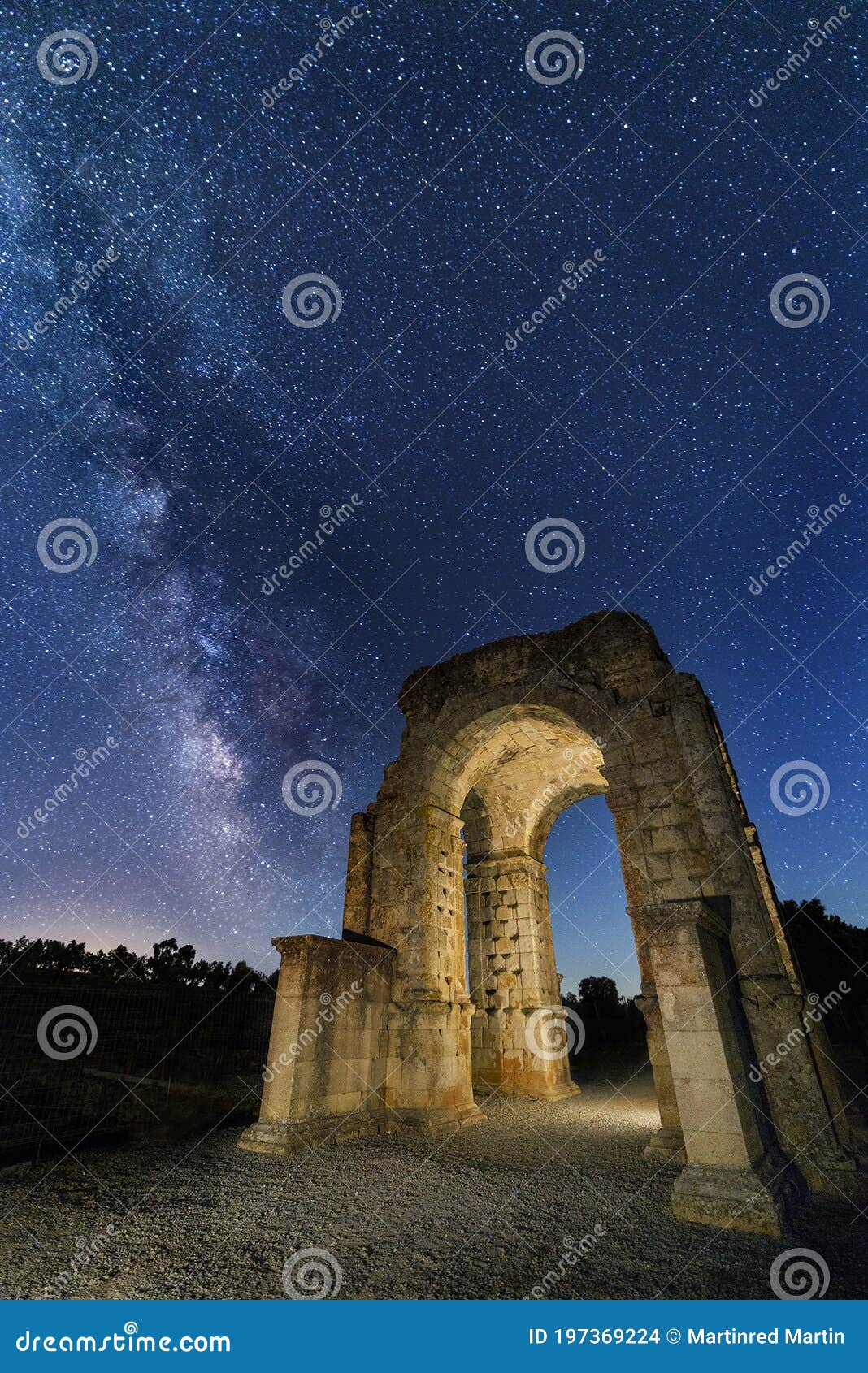 roman arch of caparra under the stars with the milky way