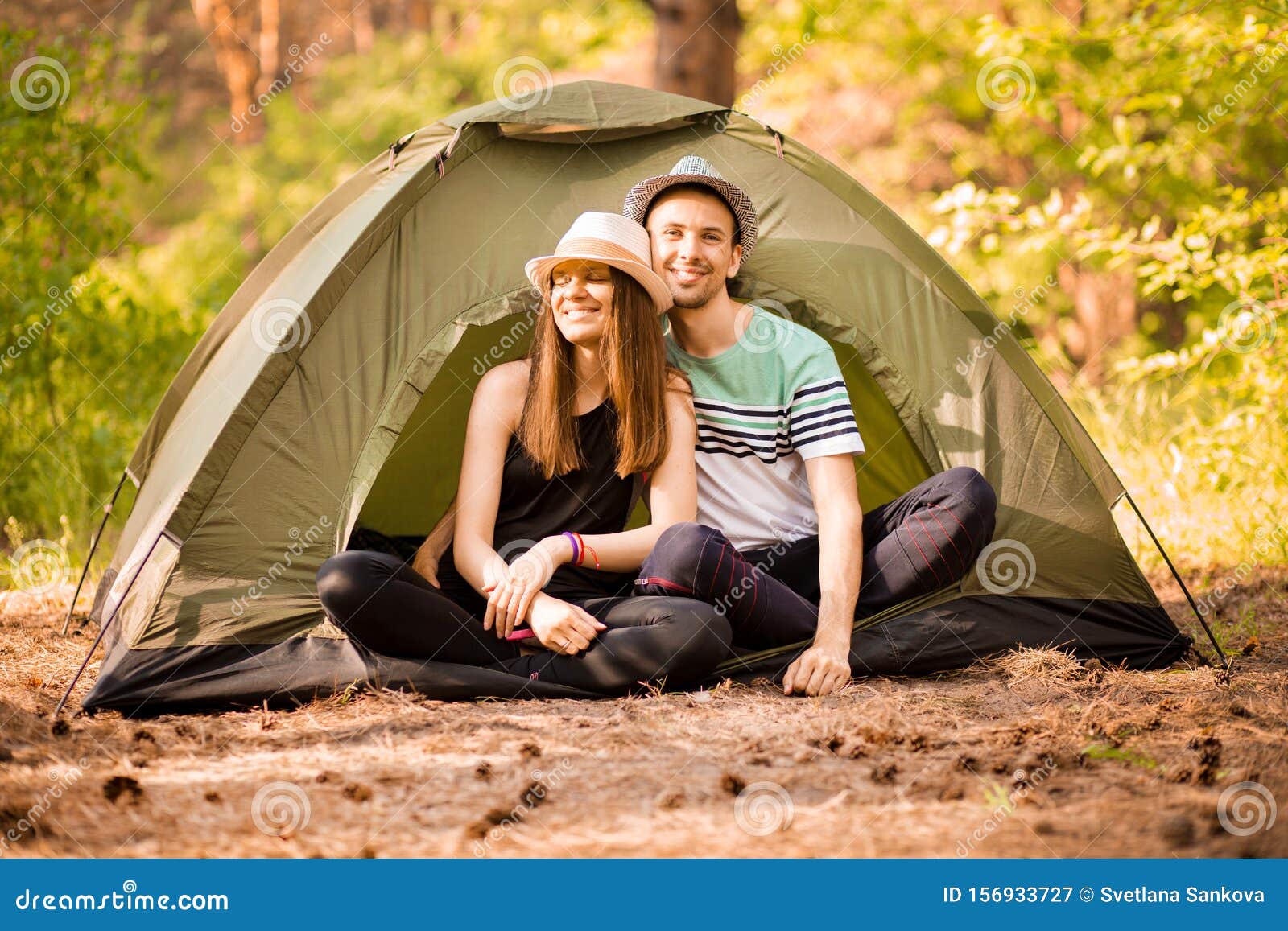 Romantic Couple Camping Outdoors And Sitting In Tent Happy Man And