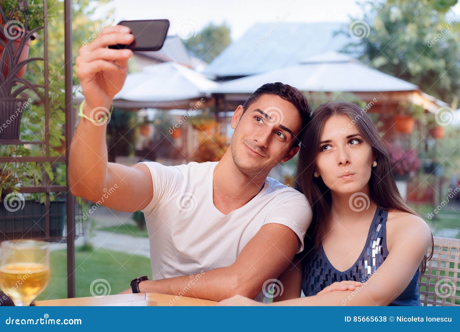 Romantic Couple On A Date At The Restaurant Taking A Selfie Stock Photo