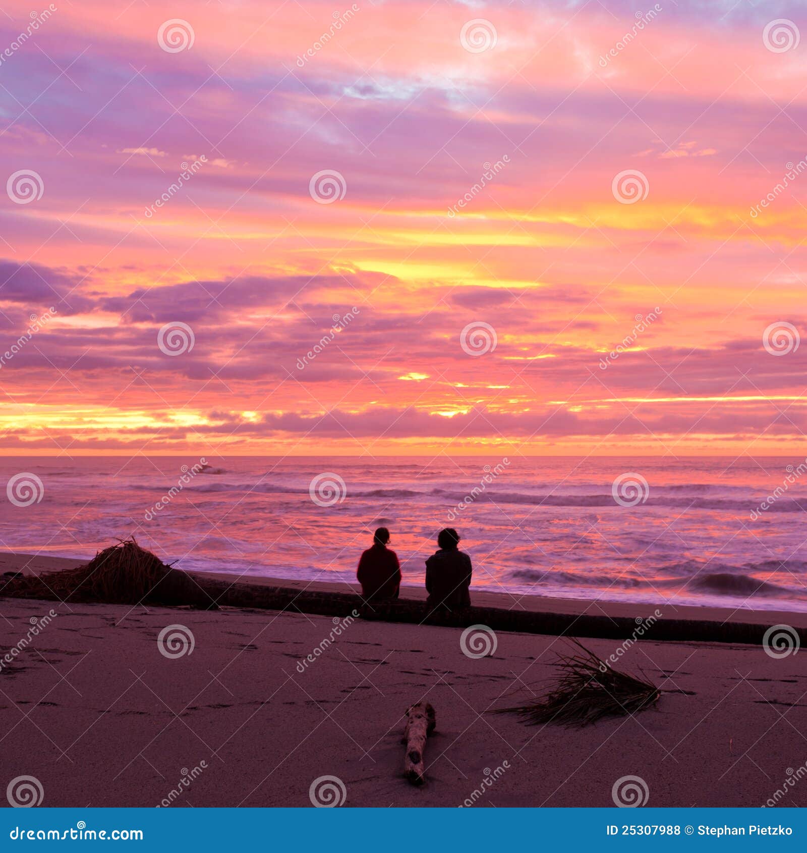 romantic couple enjoy spectacular beach sunset