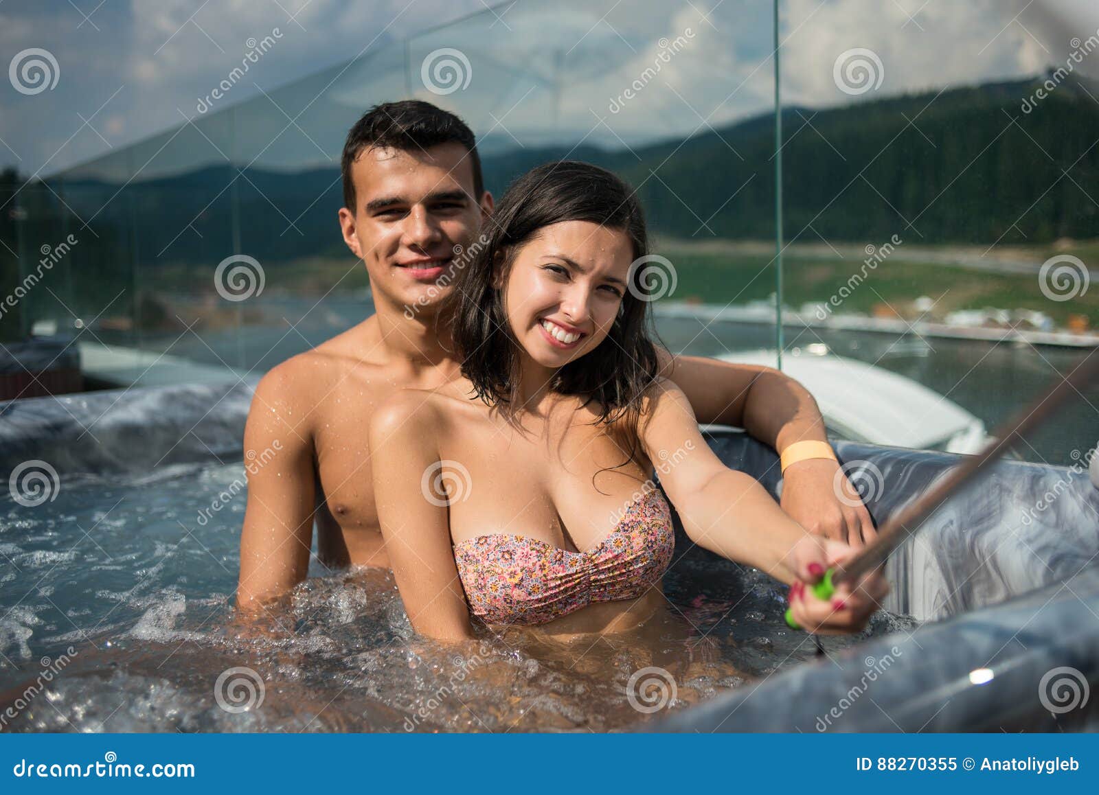 Romantic Couple Enjoying Jacuzzi Outdoors And Taking