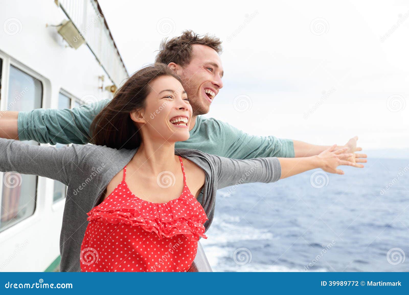 Romantic couple having fun laughing in funny pose on cruise ship boat 