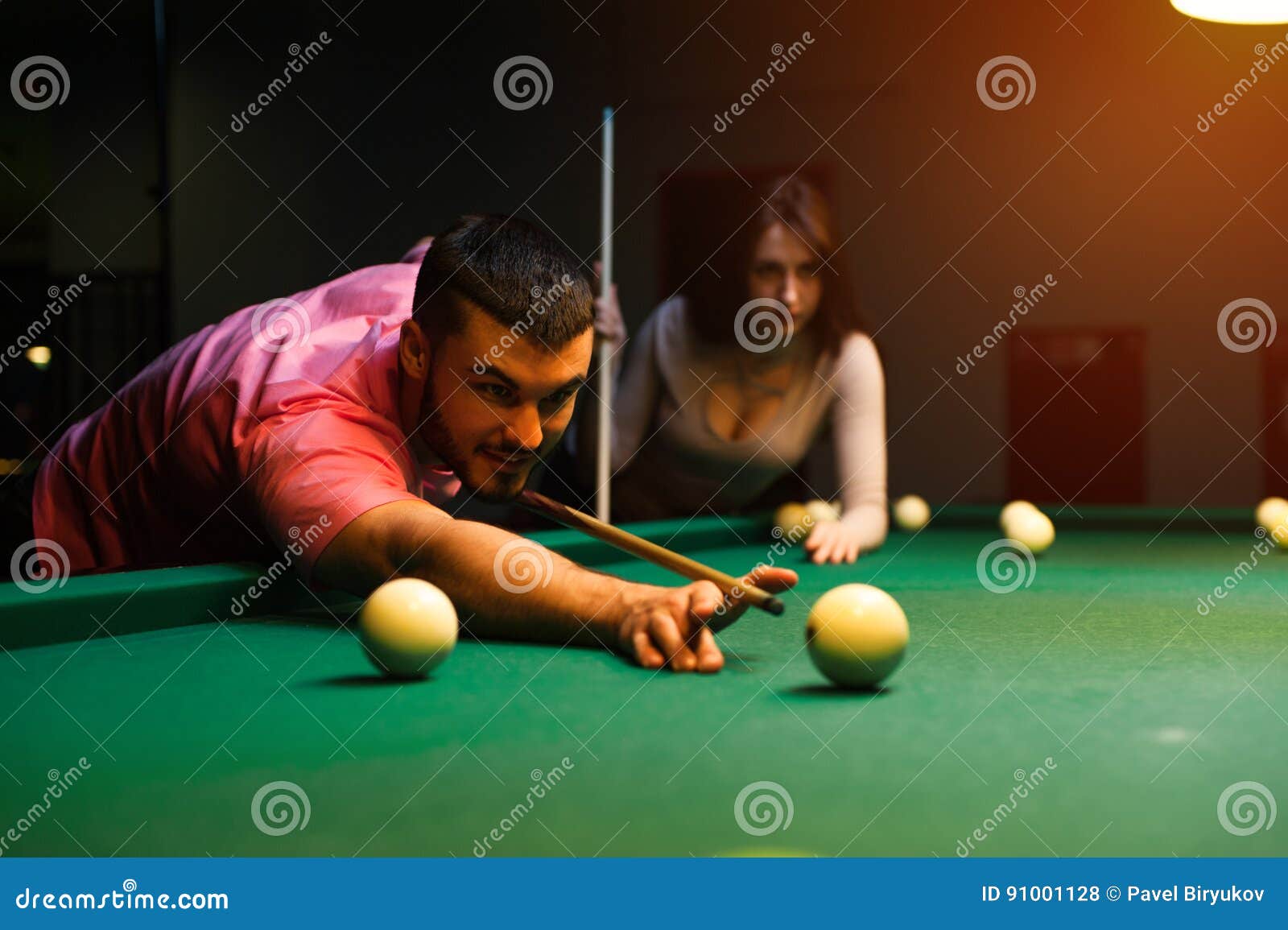 Romantic Couple Having Fun Playing Billiard Game Stock Photo