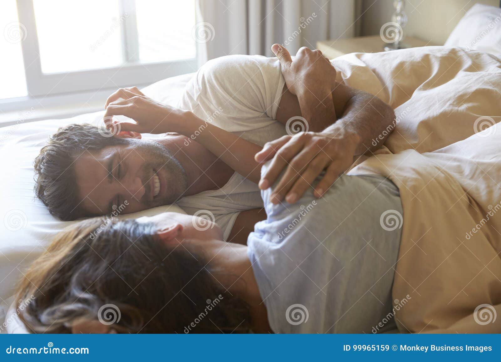 romantic couple lying in bed together