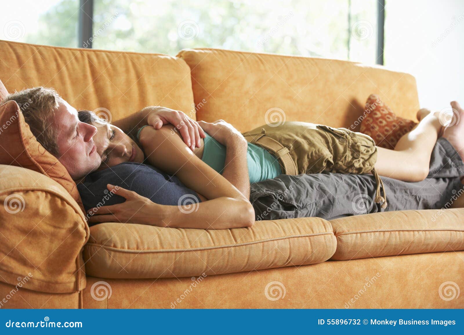 Romantic Couple Lying On Sofa At Home Stock Photo Image Of Lounge