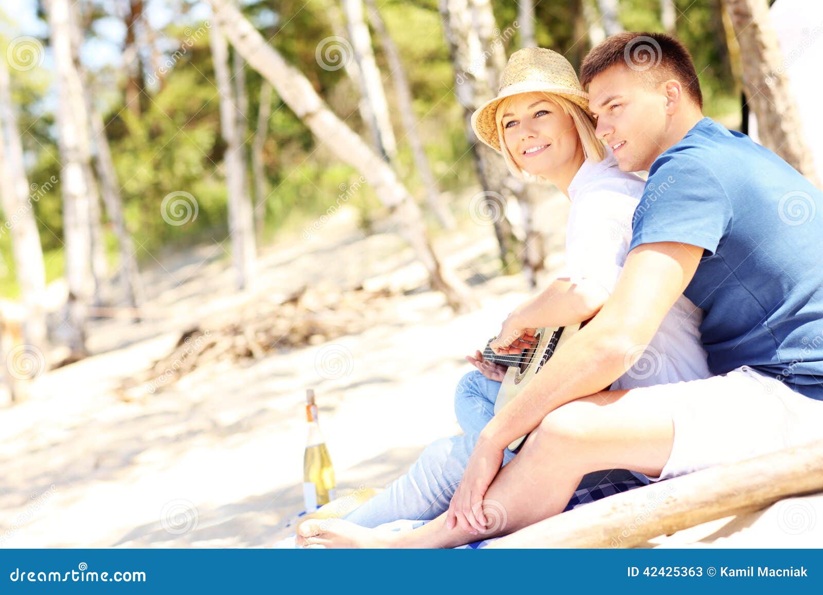 Romantic Couple  Playing Guitar  At The Beach Stock Image 