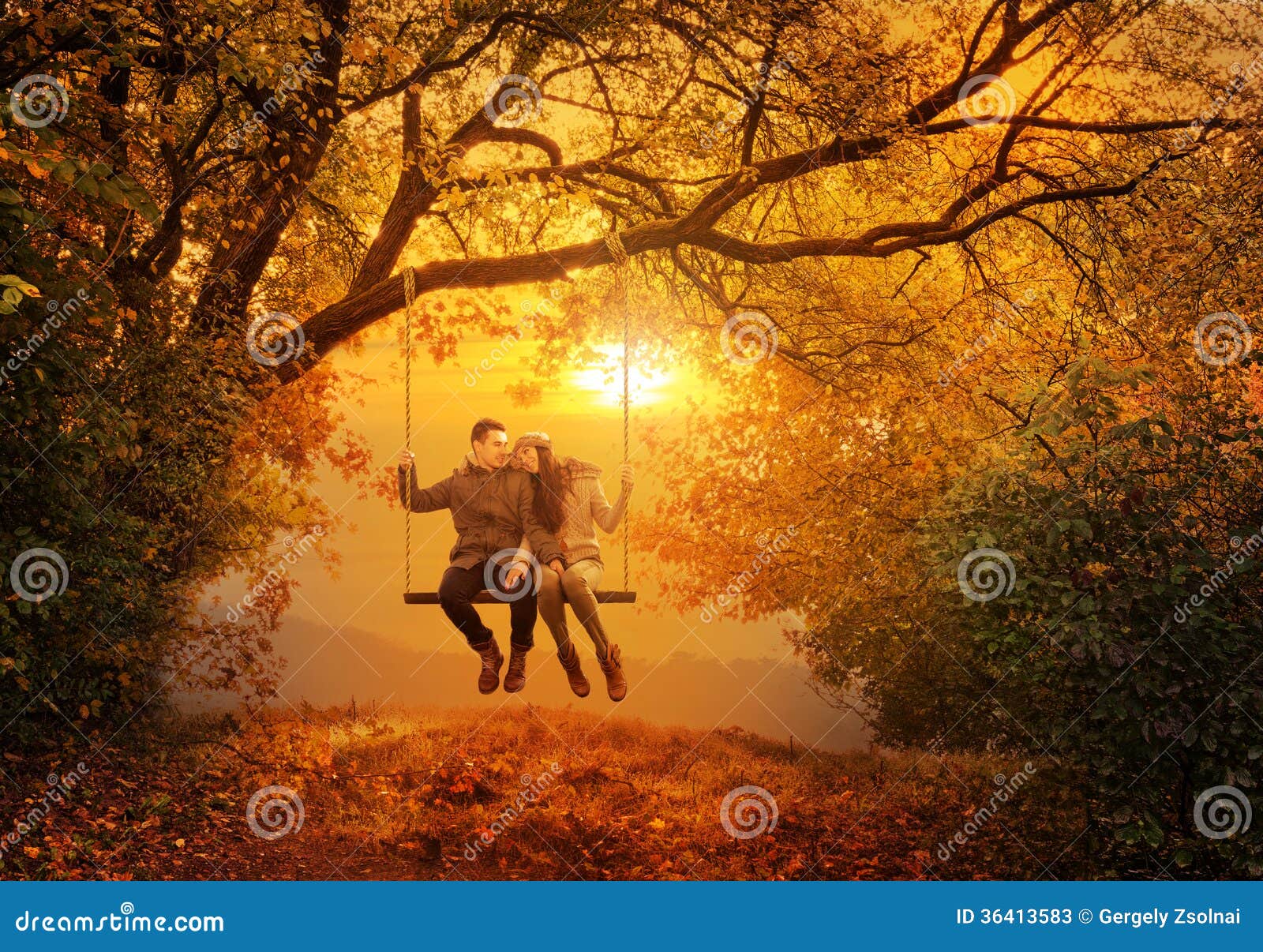 romantic couple swing in the autumn park