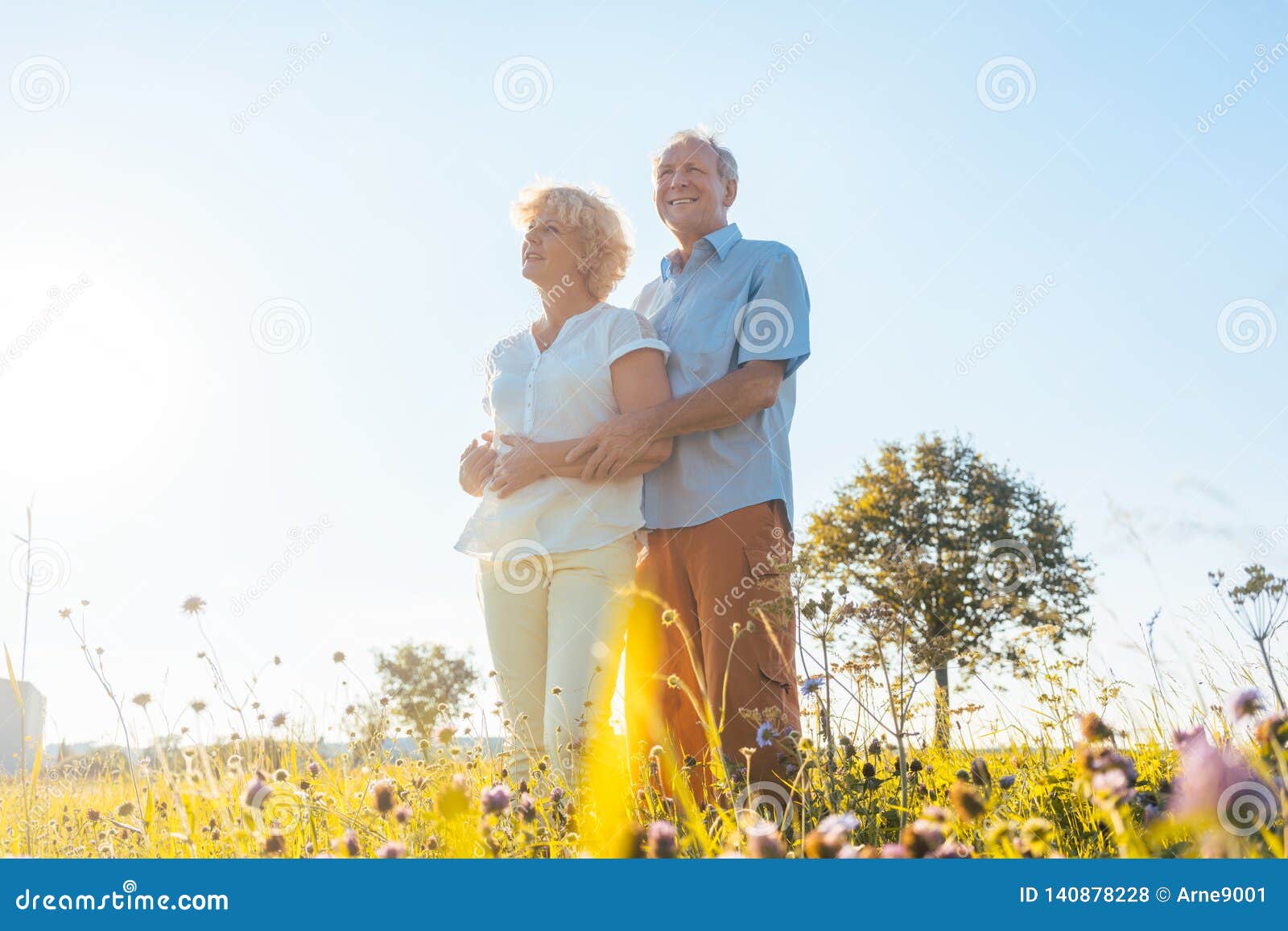 romantic elderly couple enjoying health and nature in a sunny day of summer