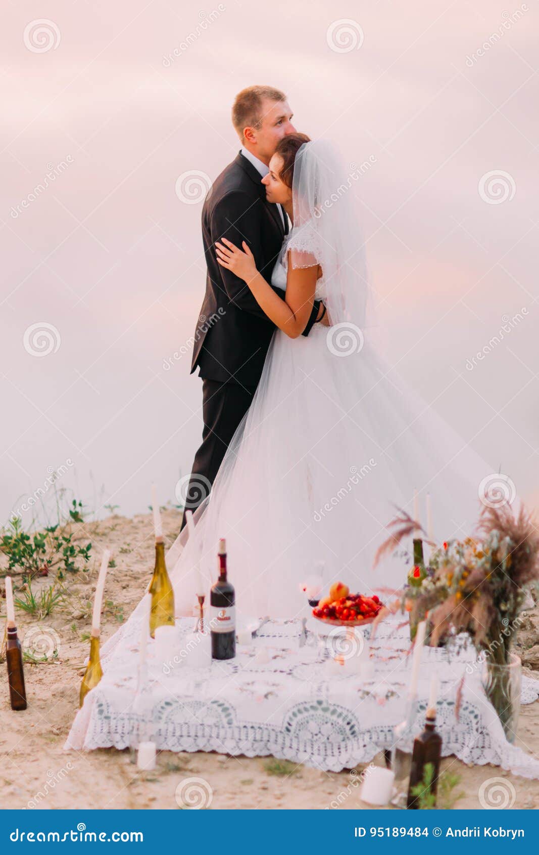 Romantic Full Length View Of The Hugging Newlyweds Behind The Picnic