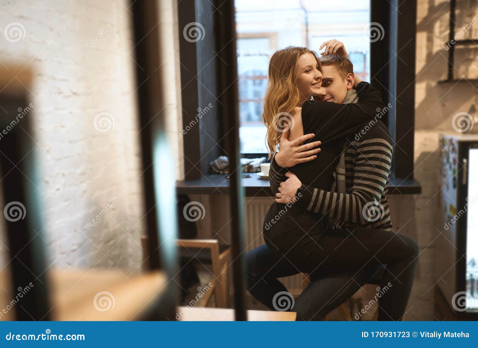 Romantic Happy Couple Sitting Over the Window in Cafe and Hugging ...