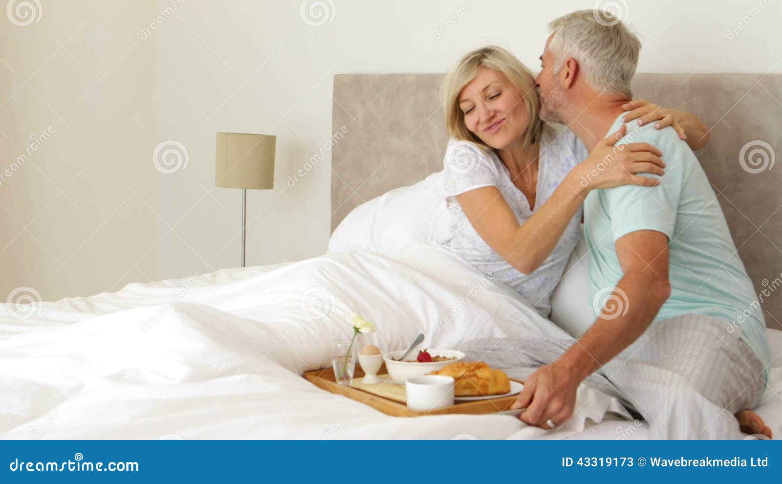 Romantic Husband Bringing His Smiling Wife Breakfast In Bed Stock