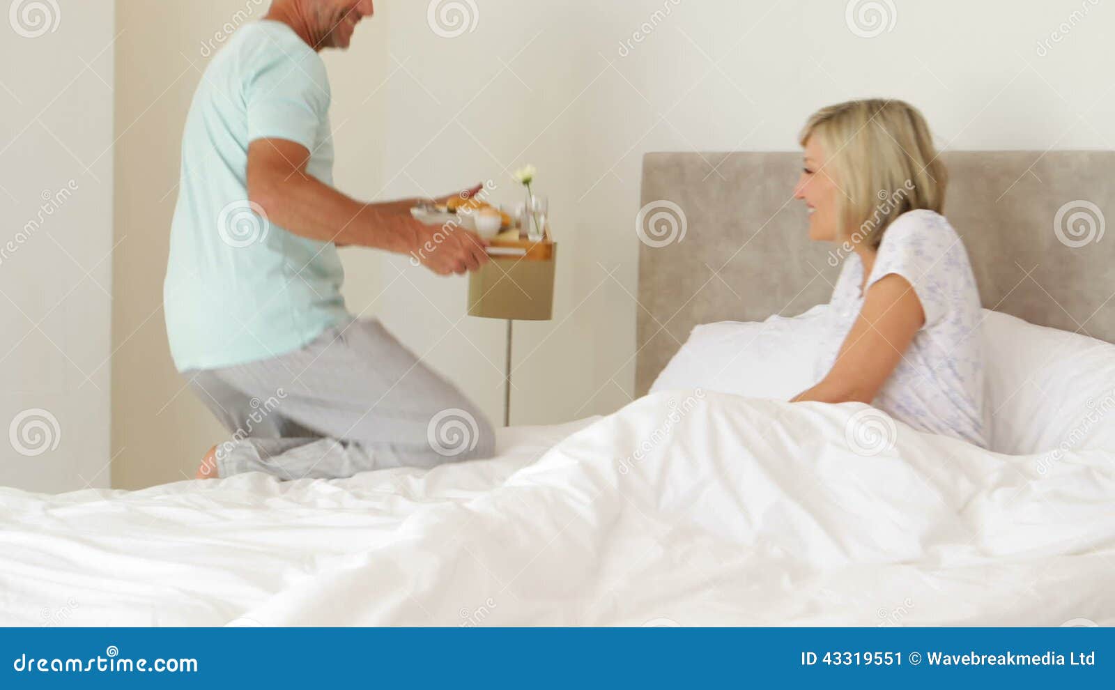 Romantic Husband Bringing His Smiling Wife Breakfast In Bed Stock