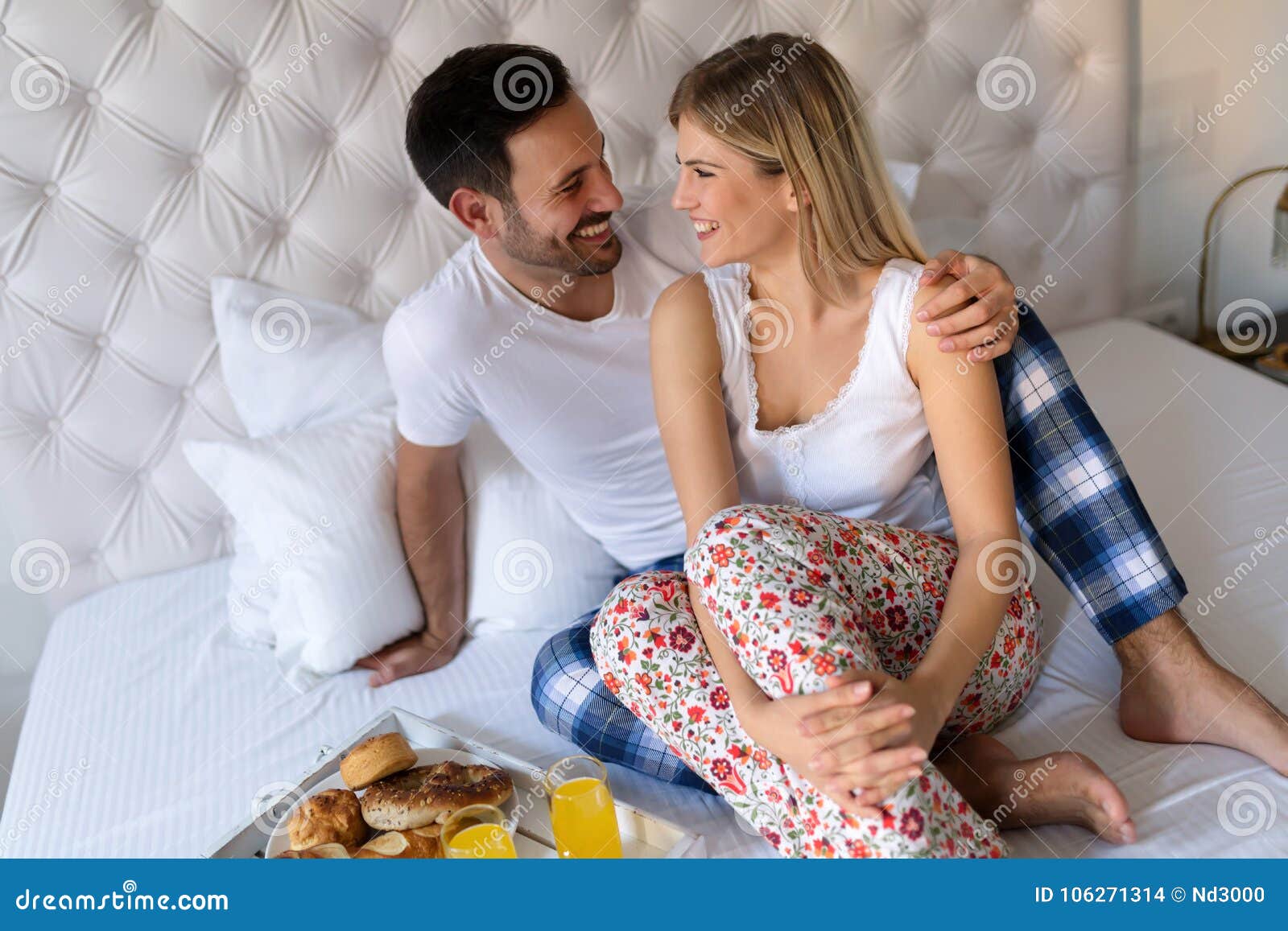 Romantic Husband Waking Wife with Breakfast in Bed Stock Photo photo