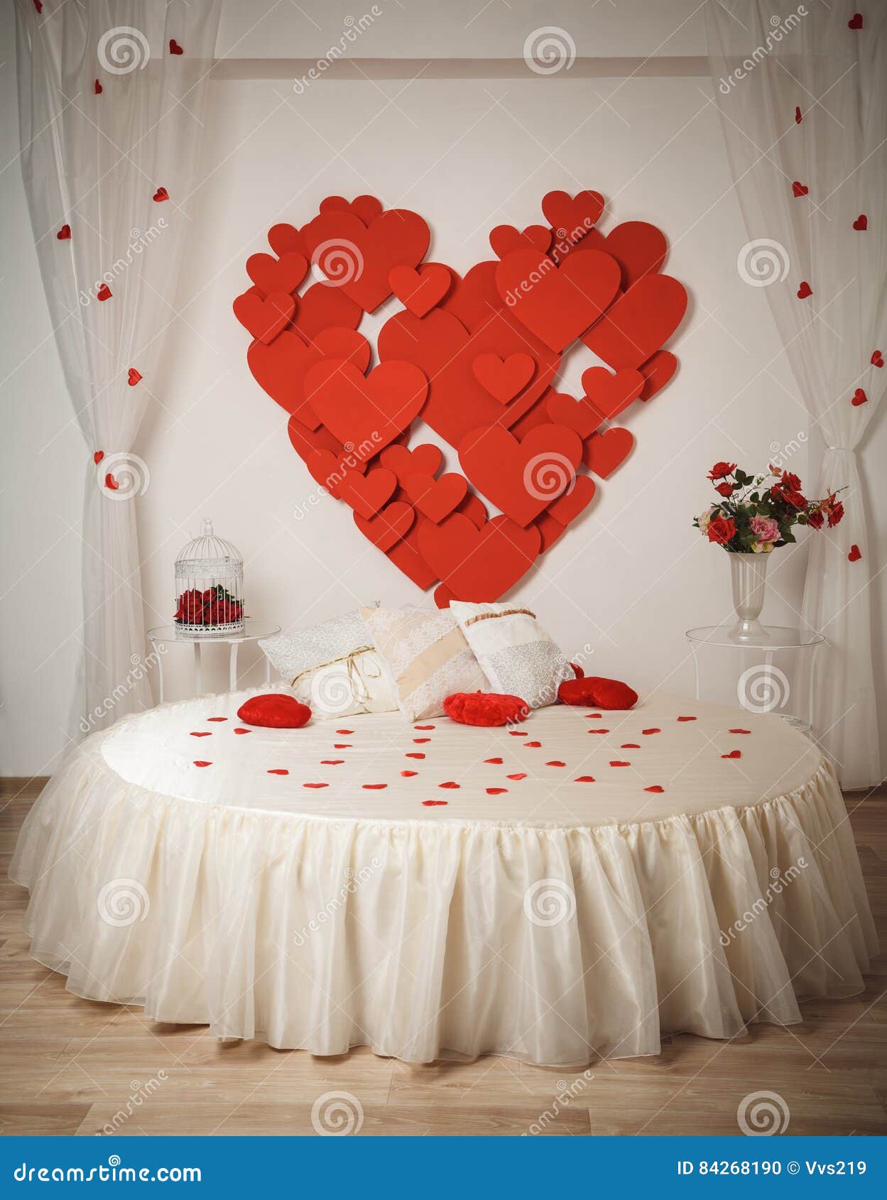 Romantic Interior with Round Bed and Hearts on the Wall. Stock Photo