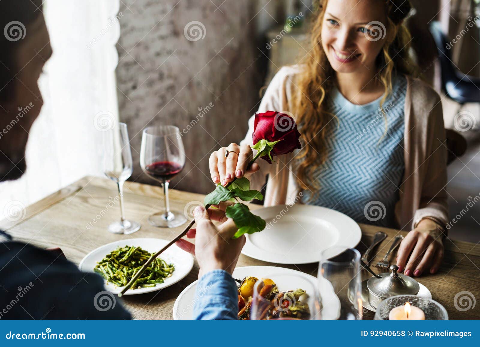 romantic man giving a rose to woman on a date