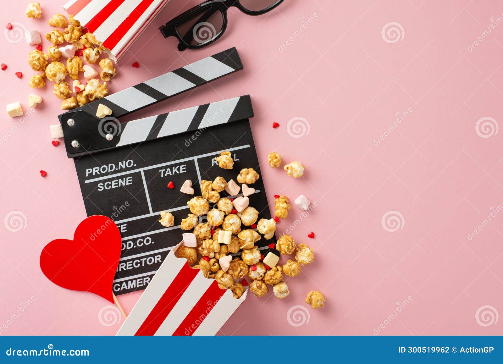 overhead shot of clapperboard, 3d glasses, striped popcorn boxes, heart-themed decor, marshmallows on pink background