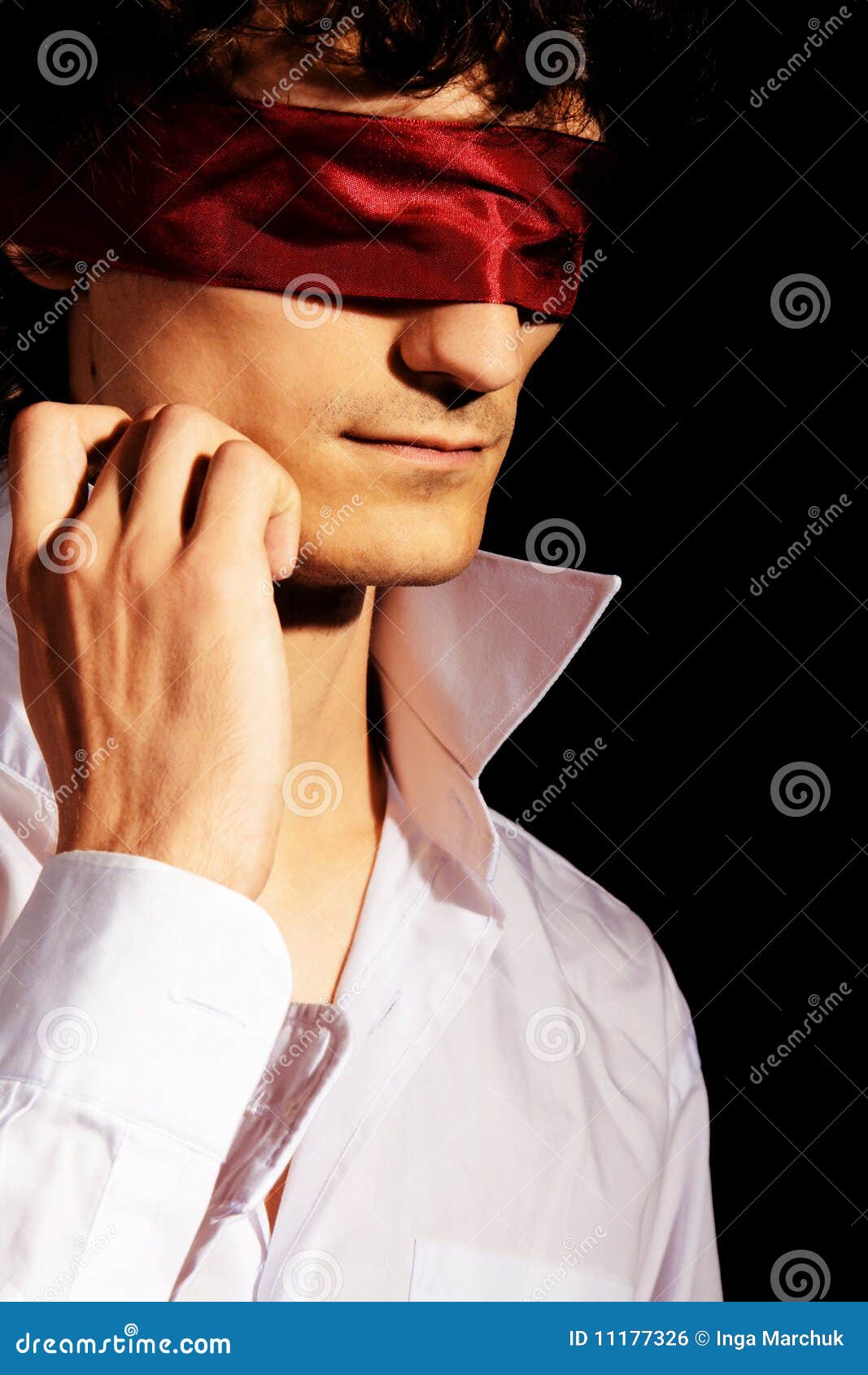 Mysterious image of a blindfolded man in a dark room stock photo