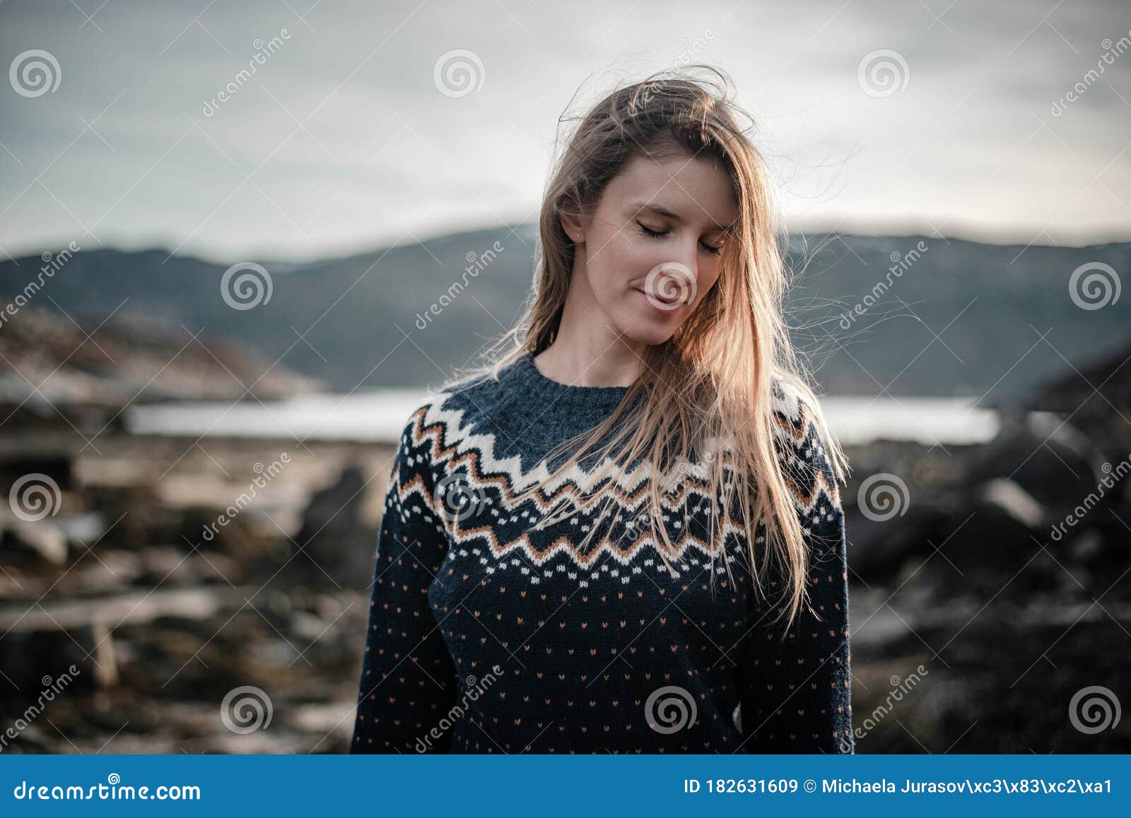Romantic Portrait of Young Blonde Woman Smiling and Posing Next To a ...