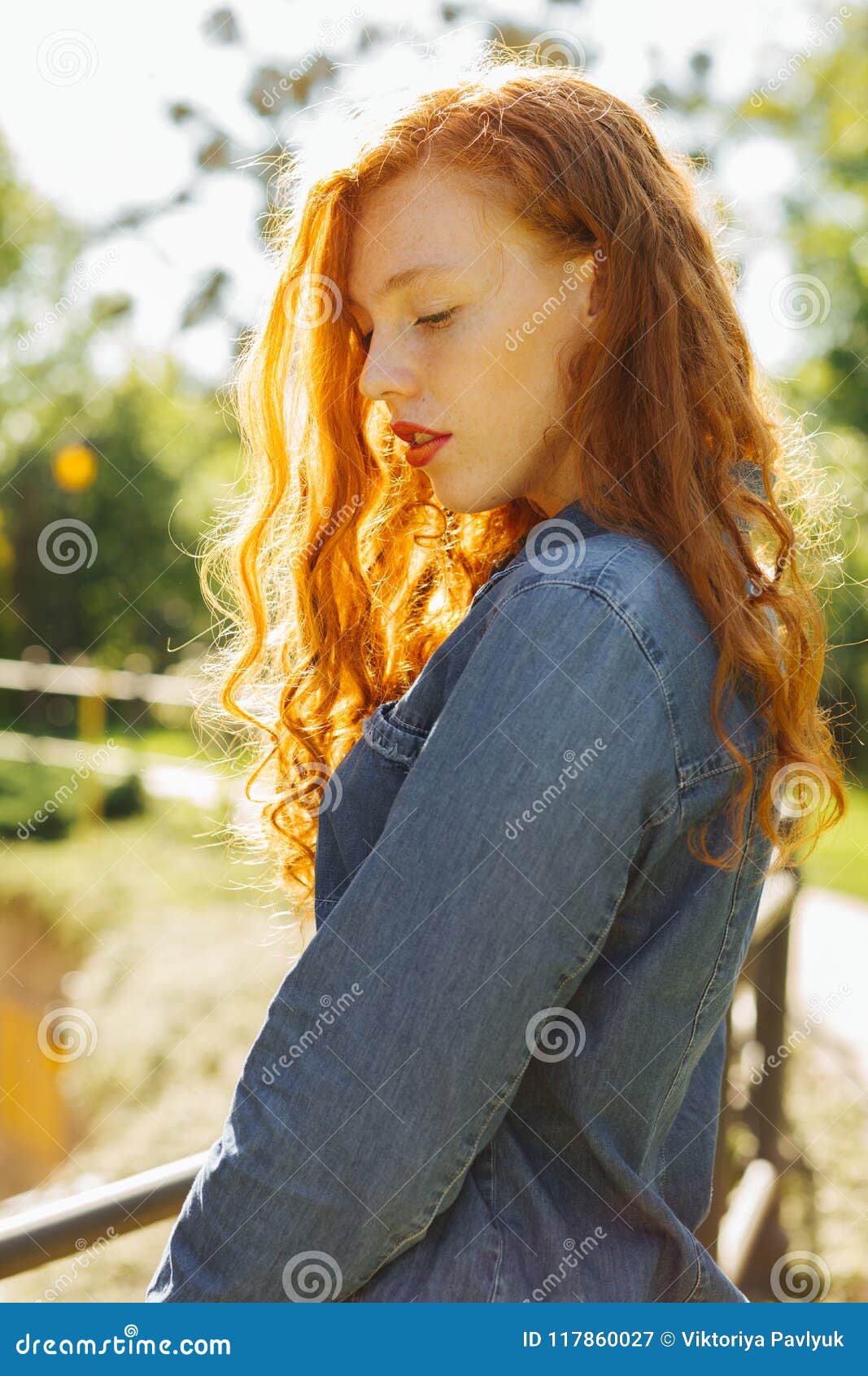 Romantic Redhead Young Woman In Denim Shirt Posing In Rays Of S Stock