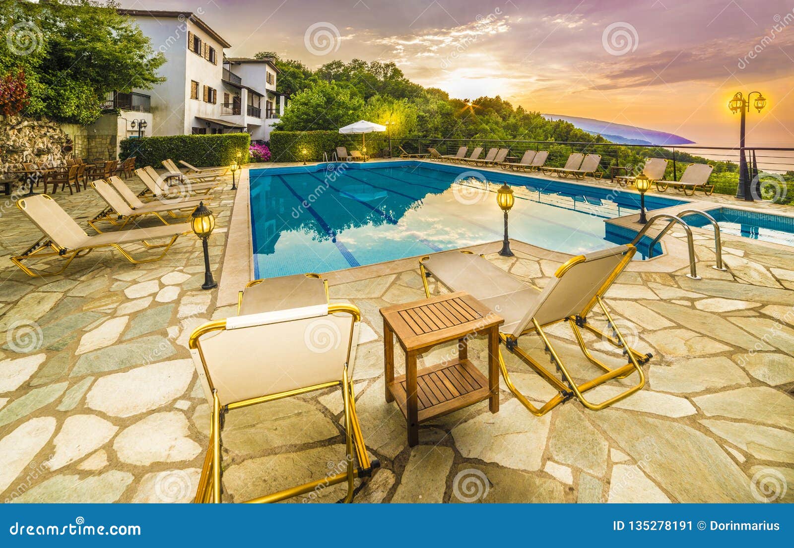 romantic sunrise over the house and swimming pools