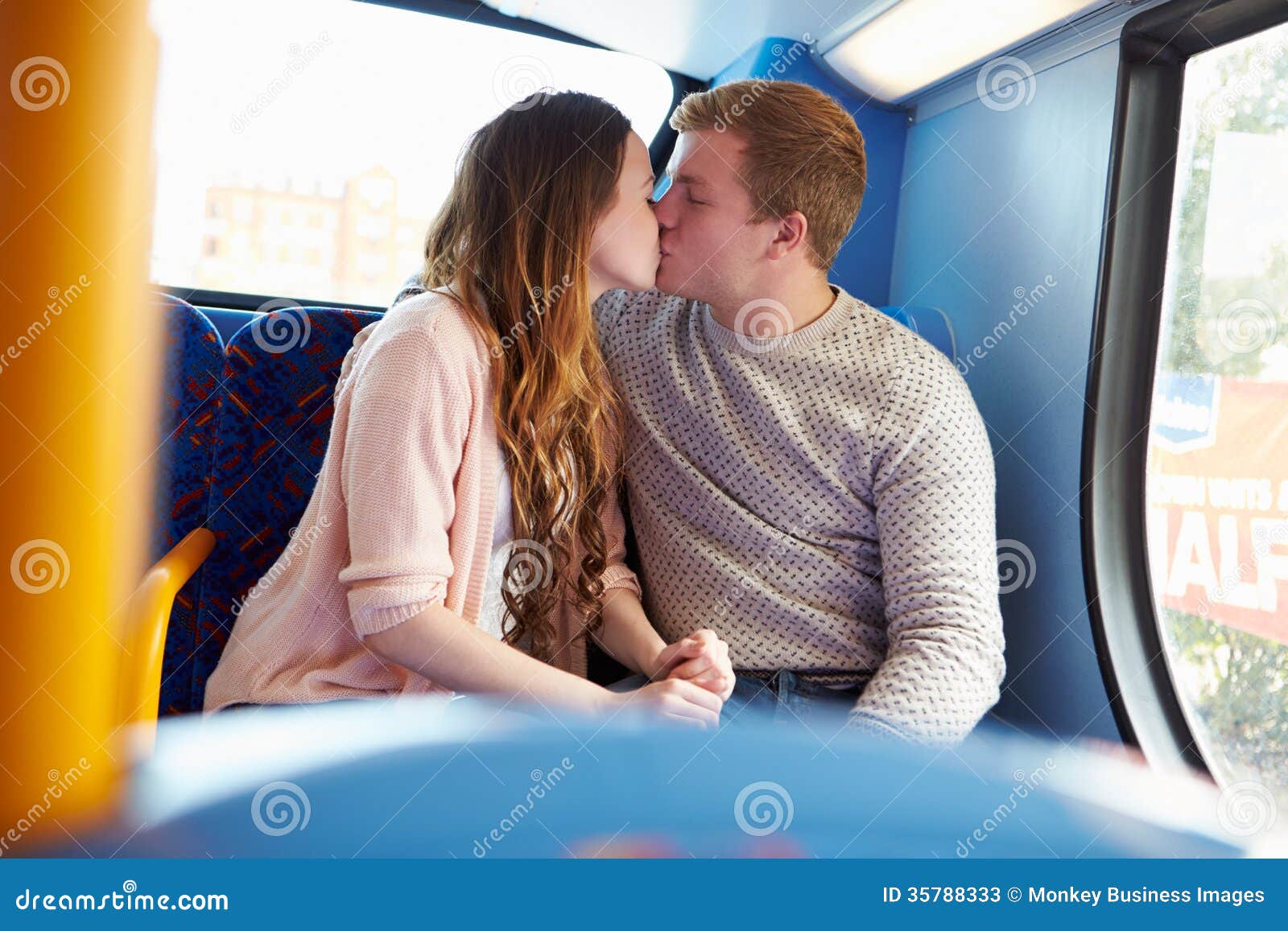 Romantic Teenage Couple Kissing On Bus Stock Photos