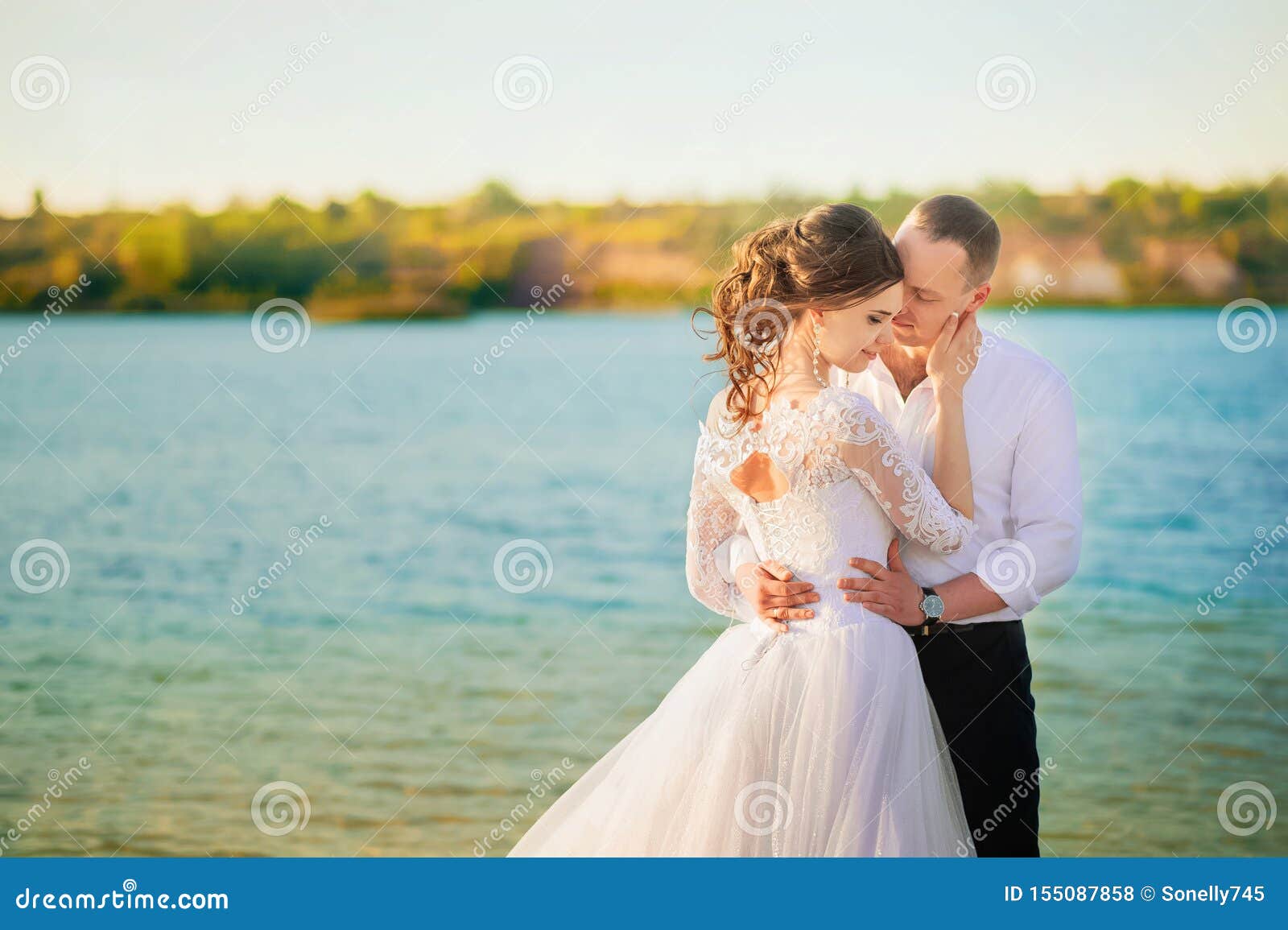 Romantic Wedding Couple on the Shore. Bride with the Groom in the ...