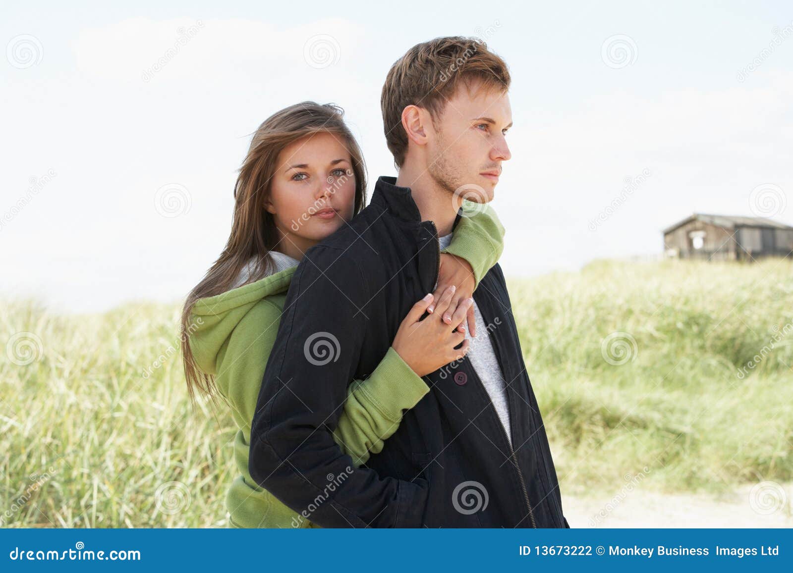 romantic young couple standing by dunes