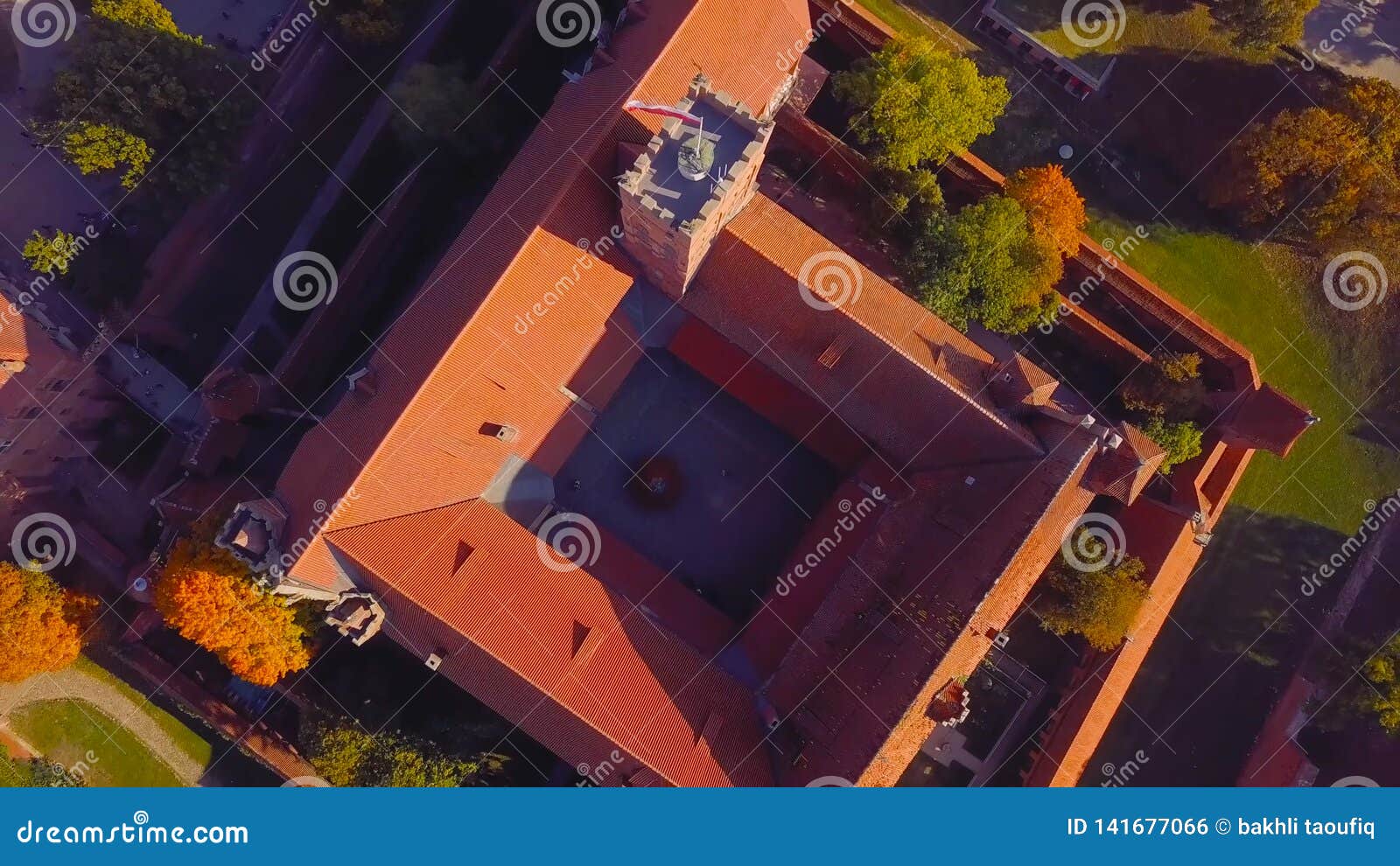 the roof of an old building in poland. the color of the wall is red in the traditional style