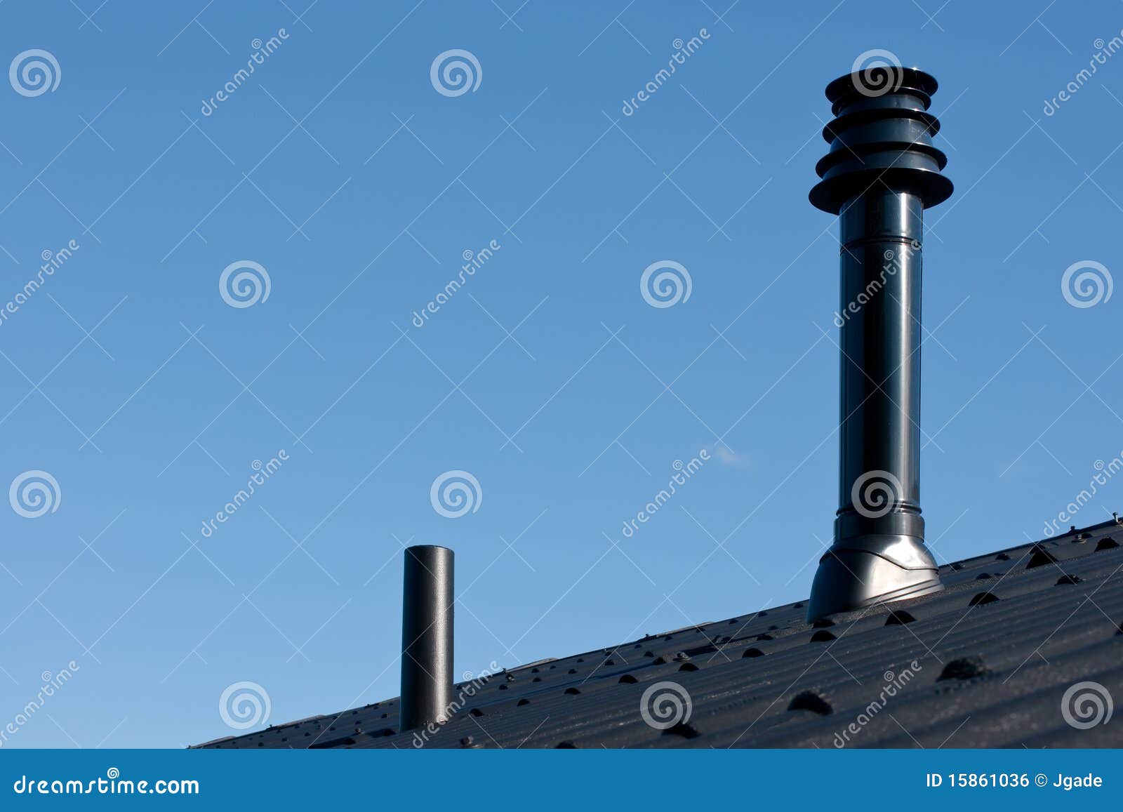 roof with ventilation pipe and flue terminal