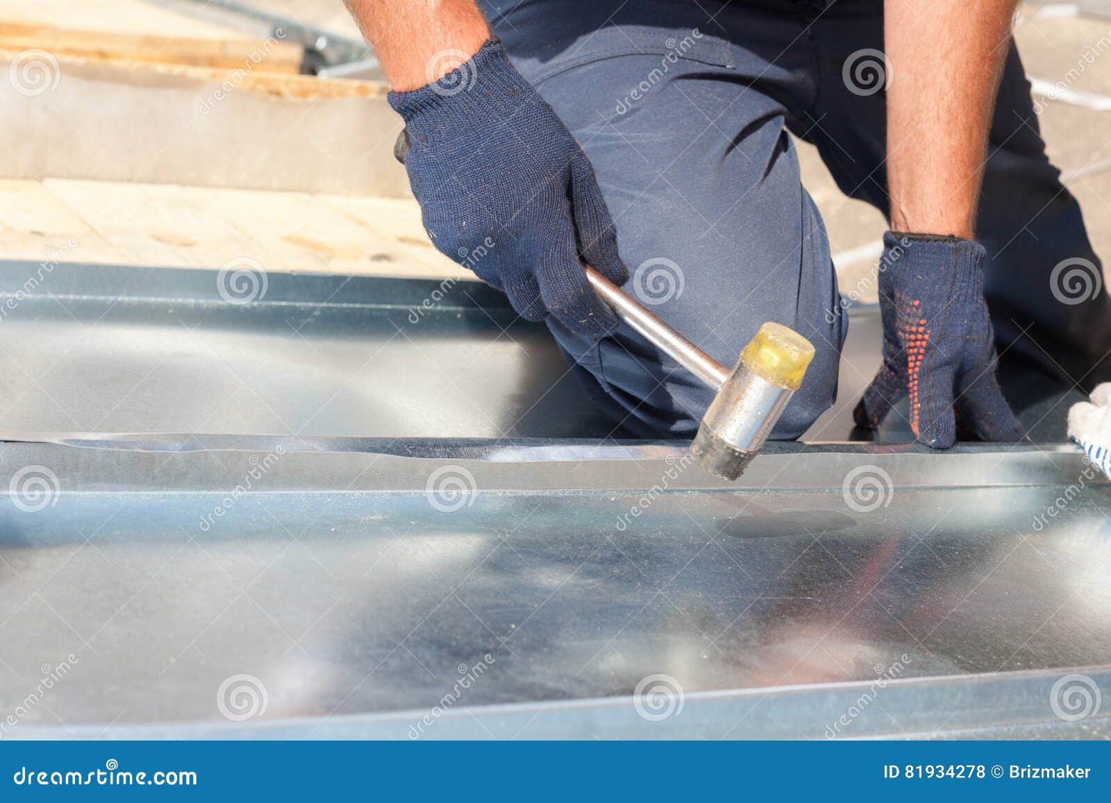 Roofer Builder Worker Finishing Folding a Metal Sheet Using Rubber