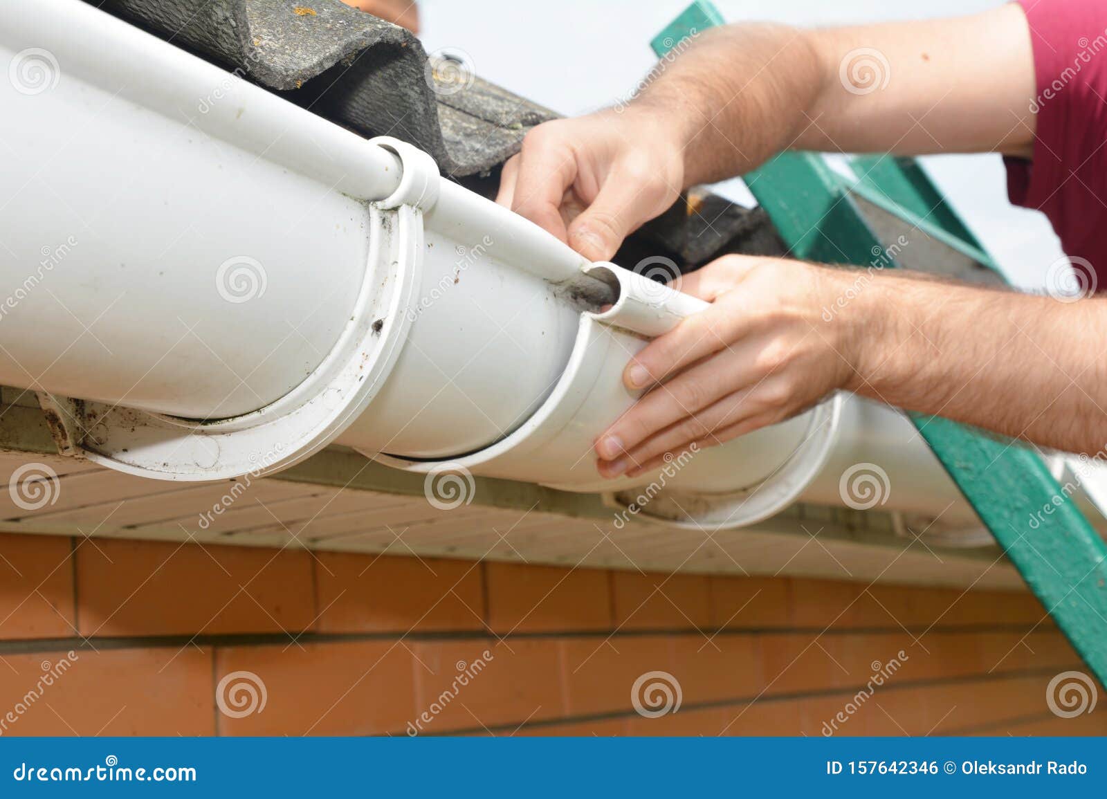 Roofer Contractor Installing and Repair Rain Gutter Pipeline Connection