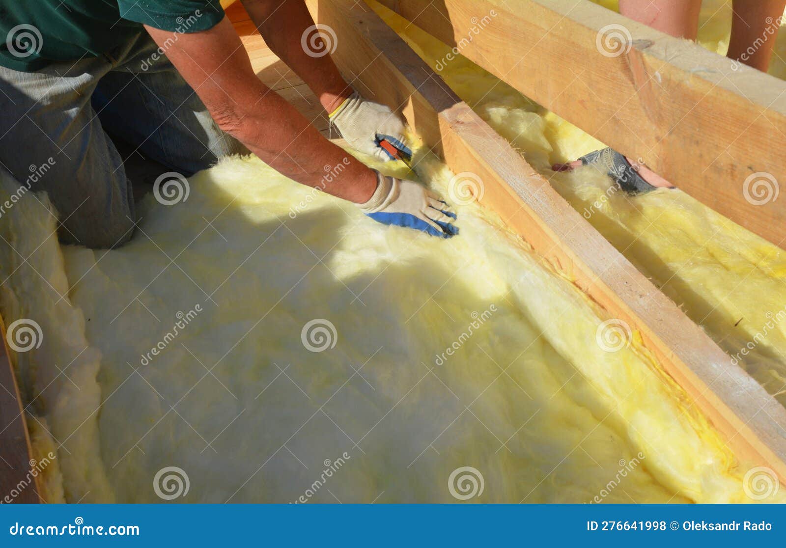 Roofer Contractor Laying Insulation in Problem Area during House