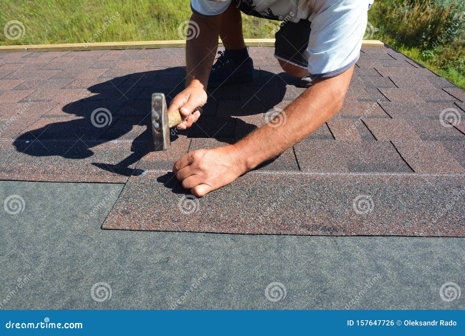 Roofer Installing Asphalt Shingles on House Roofing Construction with