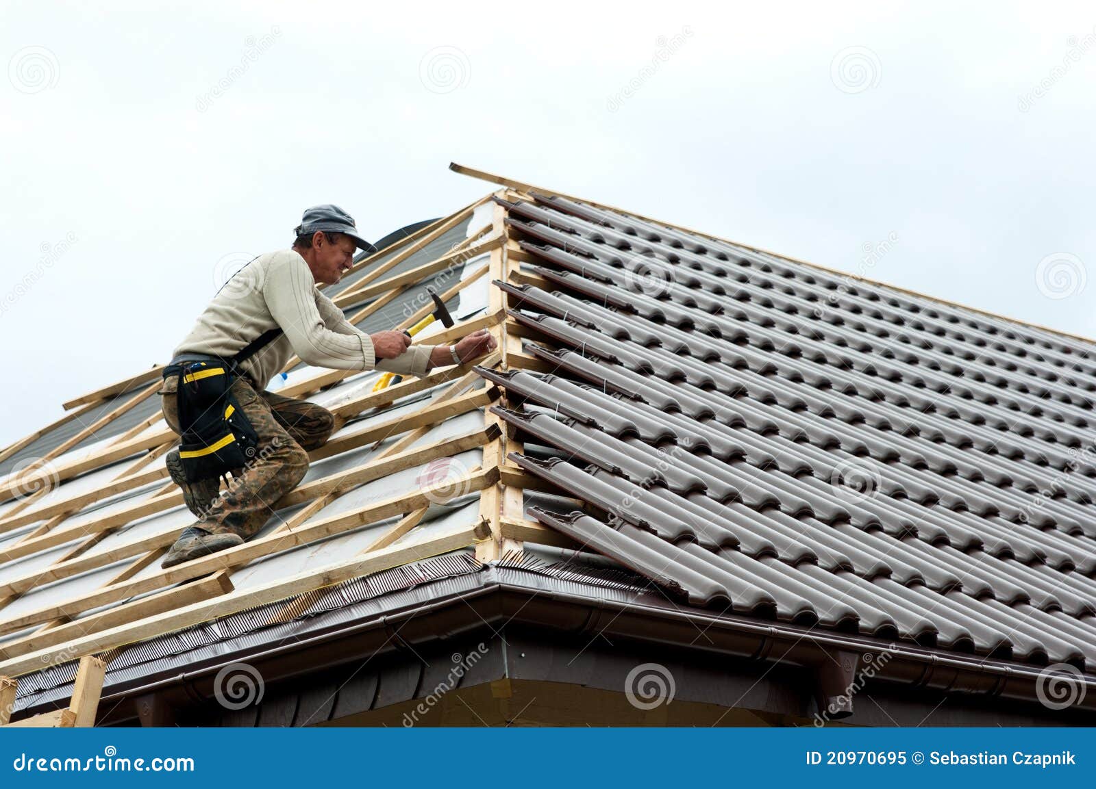 roofer laying tiles