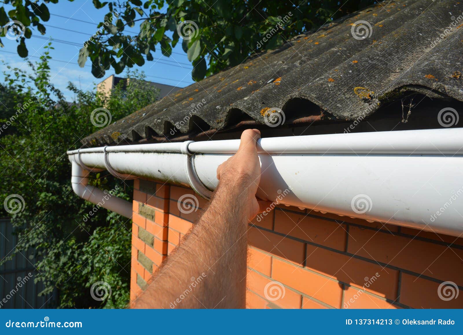 roofer repair and renovate roof gutter on old brick house asbestos roof