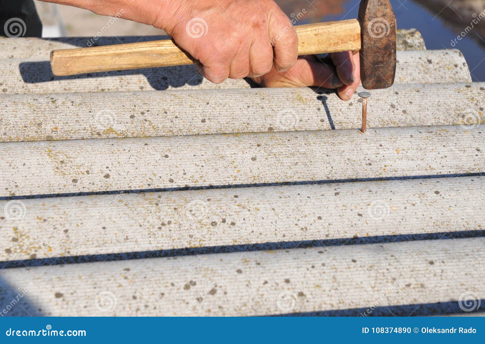 roofers replace damaged asbestos tile. repair asbestos roof. nailing roof shingles.