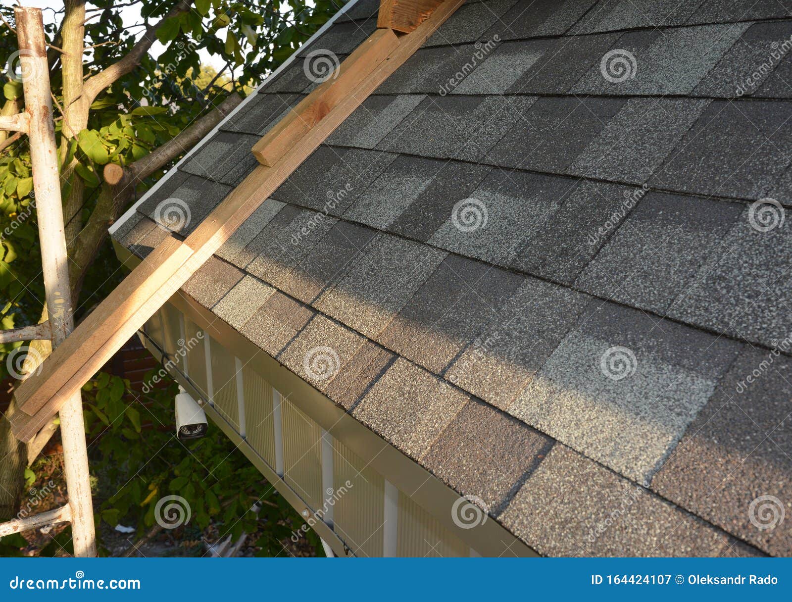 roofing construction.  installing, repair, renovate  asphalt shingles roof tiles on the rooftop outdoors