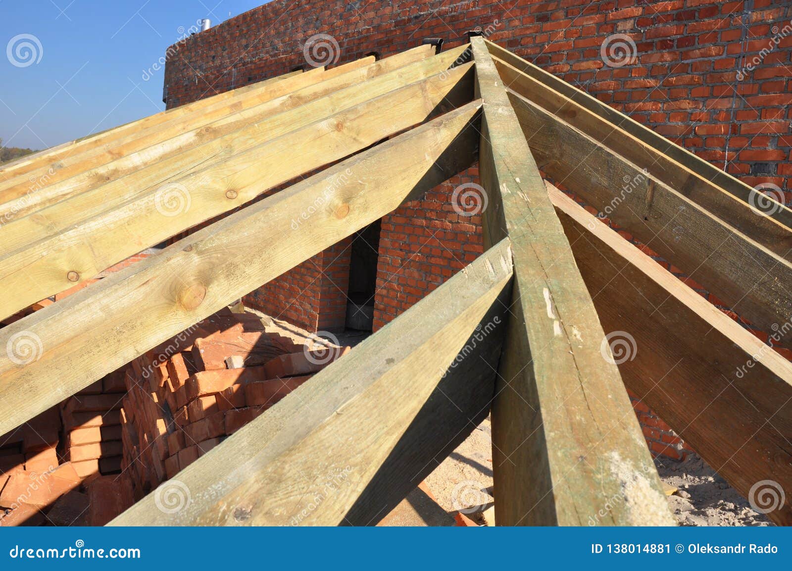 Roofing Construction With Trusses, Wooden Rafters, Eaves And Timber On Brick House Roof Corner