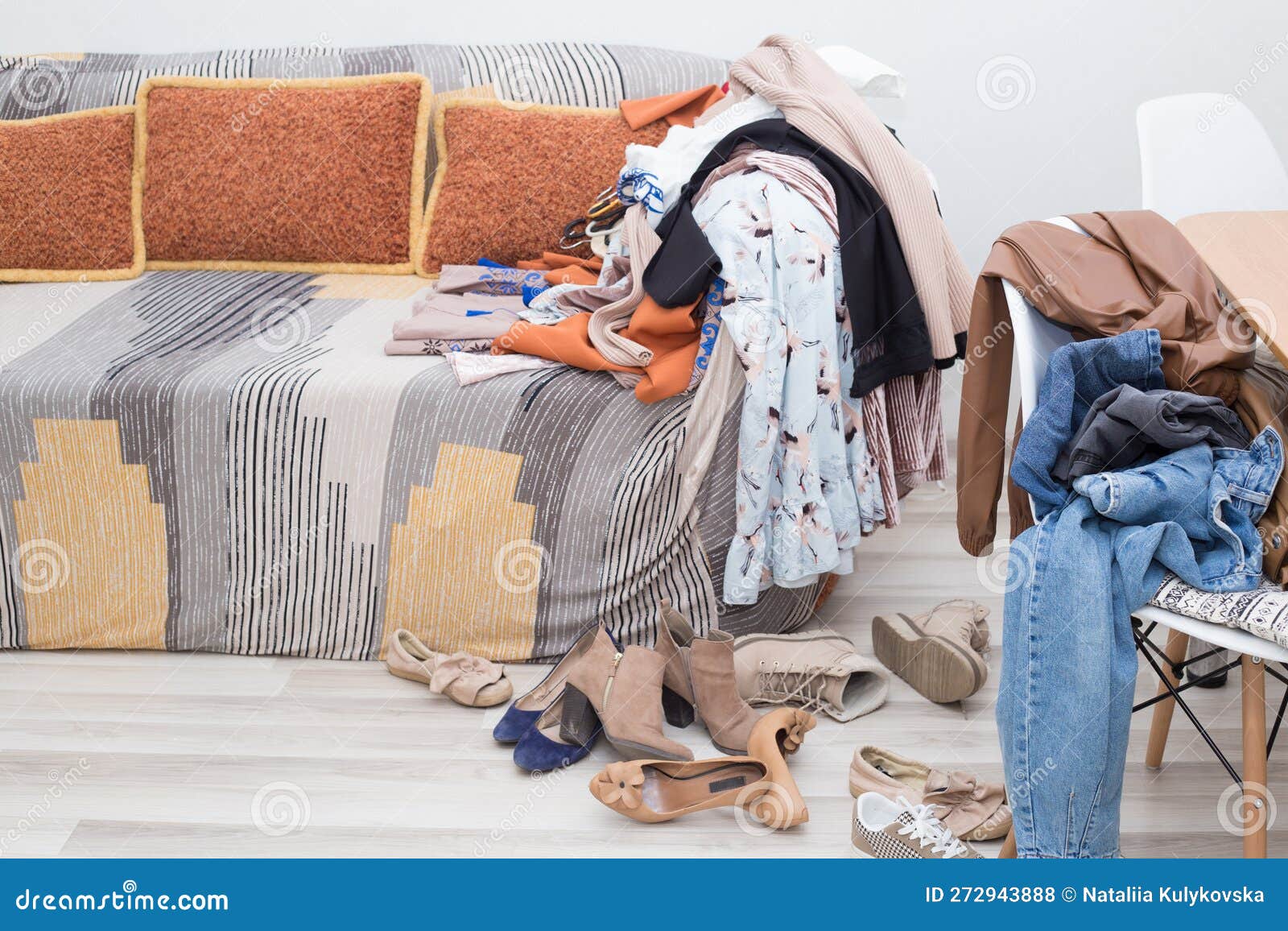 There are a Lot of Women S Clothes on the Sofa, Dresses, Jeans, Shoes on  the Chair and on the Floor. Stock Photo - Image of floor, change: 272943888